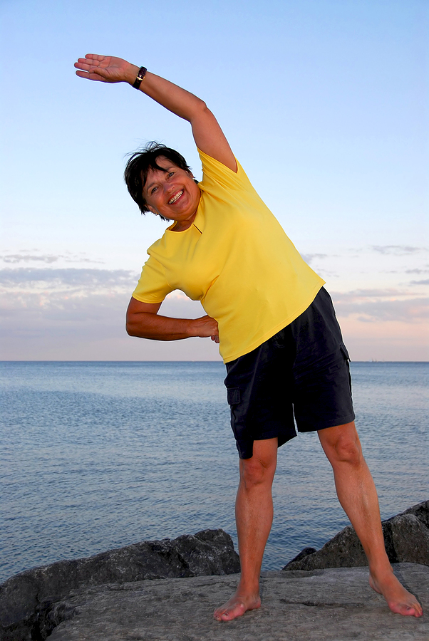 Woman exercising in front of beach